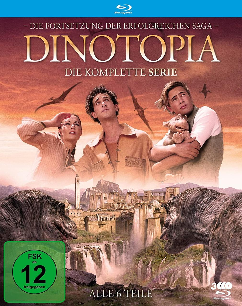Dinotopia DVD-Hülle. Drei Personen schauen zu fliegenden Dinosauriern, Stadt im Hintergrund.