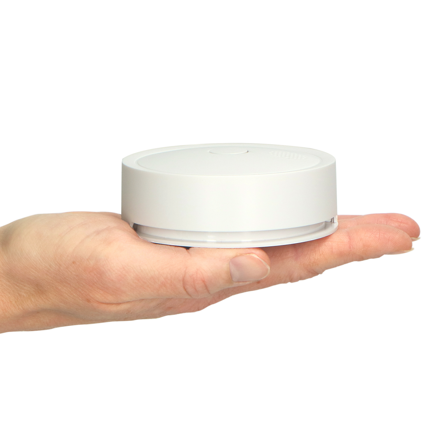 White smoke detector held in hand. White background.