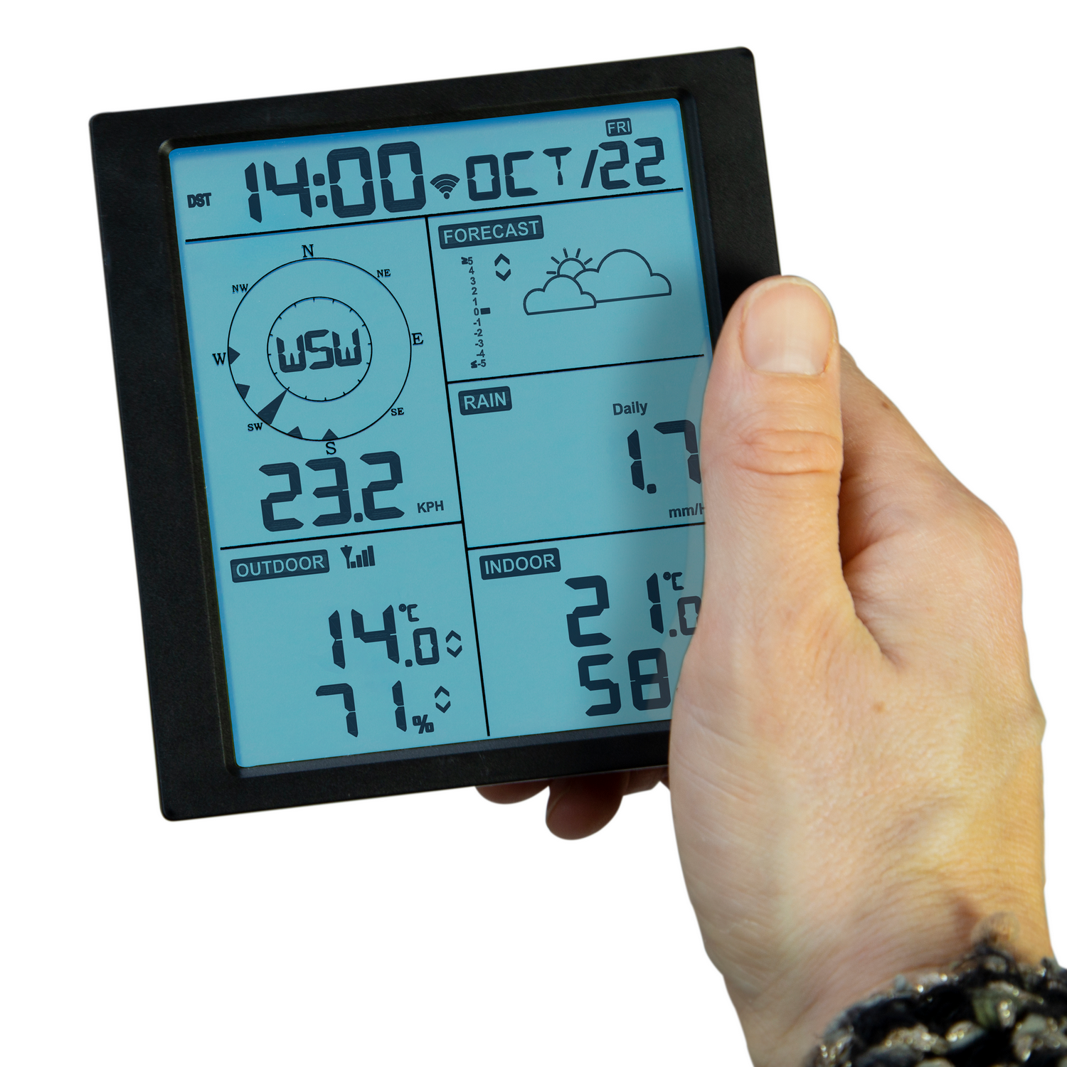 A hand holding a black digital weather station displaying time, weather, and temperature.