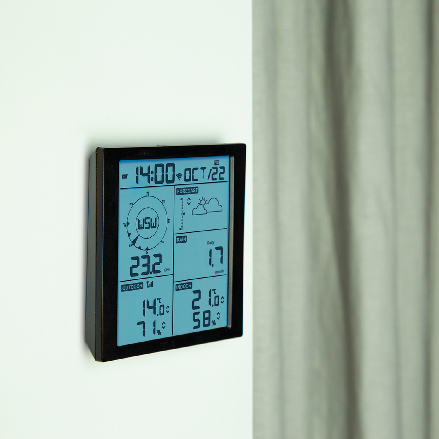 A black digital weather station displaying time, date, outdoor and indoor temperature, and forecast.