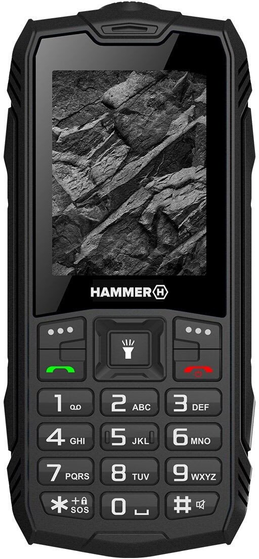 Czarny, wytrzymały smartfon. Wyświetlacz z fakturą skalną. Posiada klawiaturę numeryczną i przyciski połączeń. Marka: Hammer.