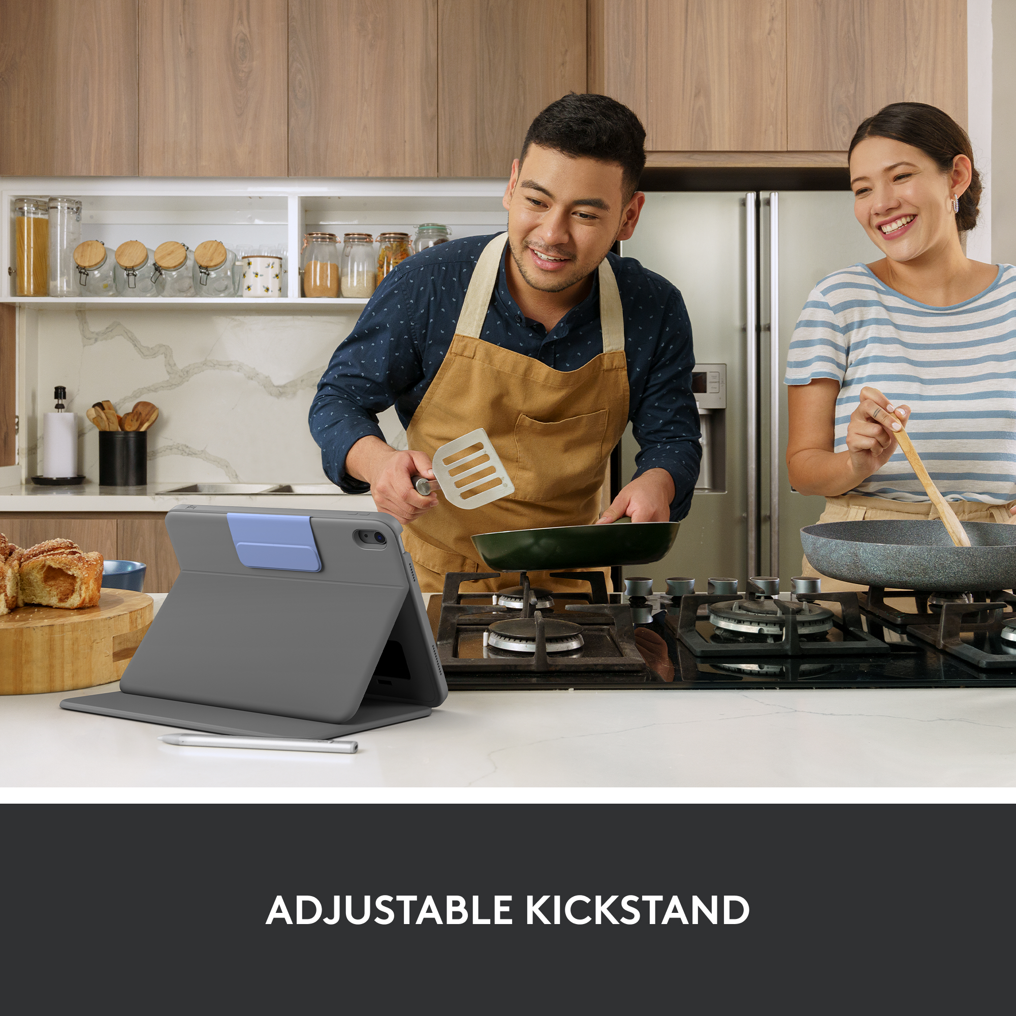 Couple cuisinant ensemble dans une cuisine, tablette visible.
