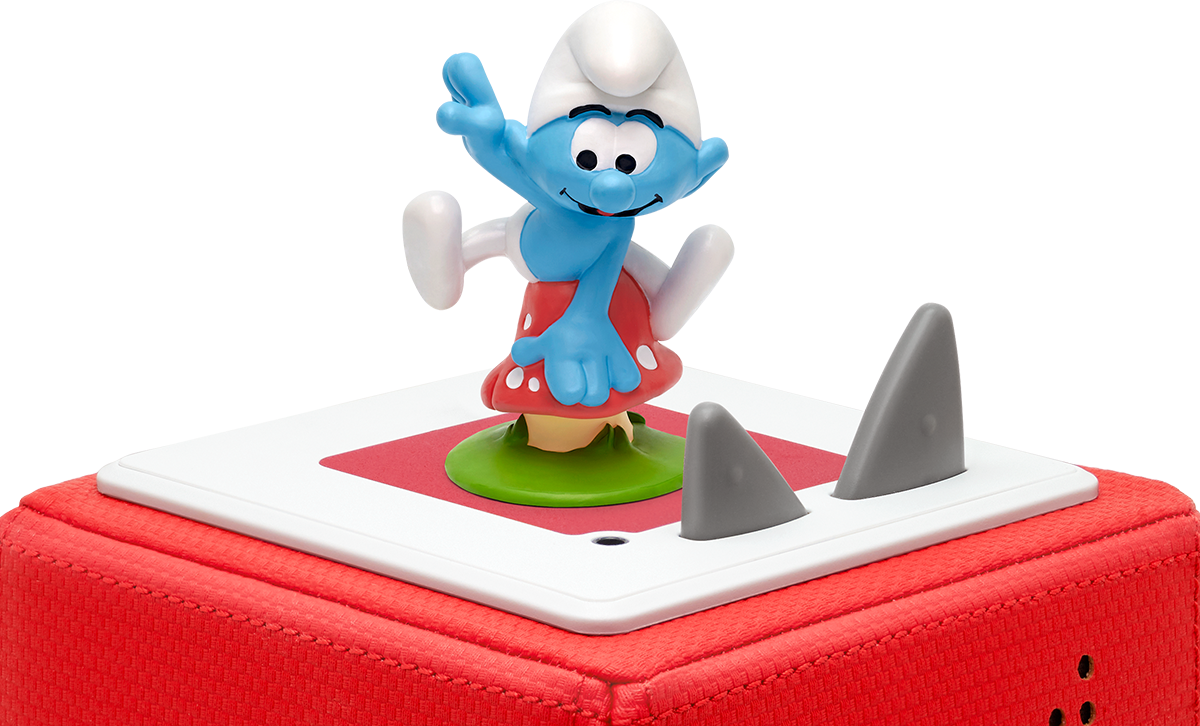 Spielzeugwürfel mit einer Schlümpfe-Figur, auf roter und weißer Basis mit Haifischflossen.