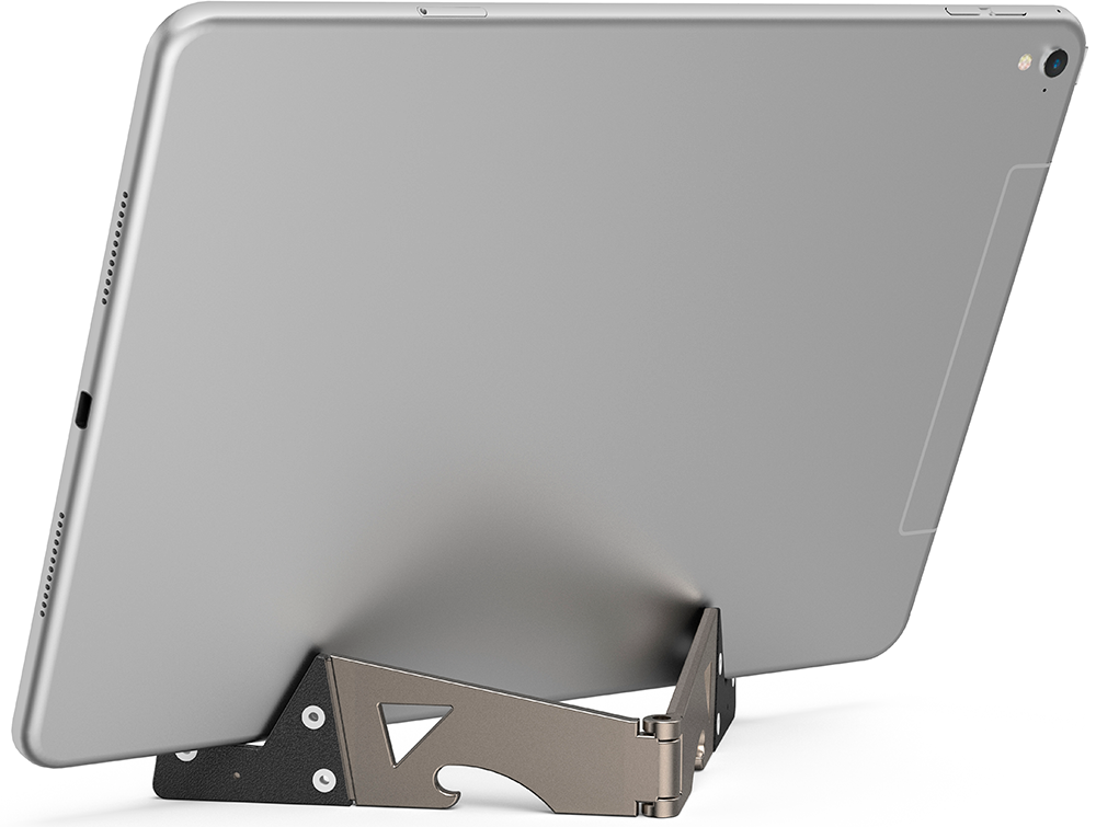 Silver tablet propped in a metal stand, back facing the viewer, on a white surface.