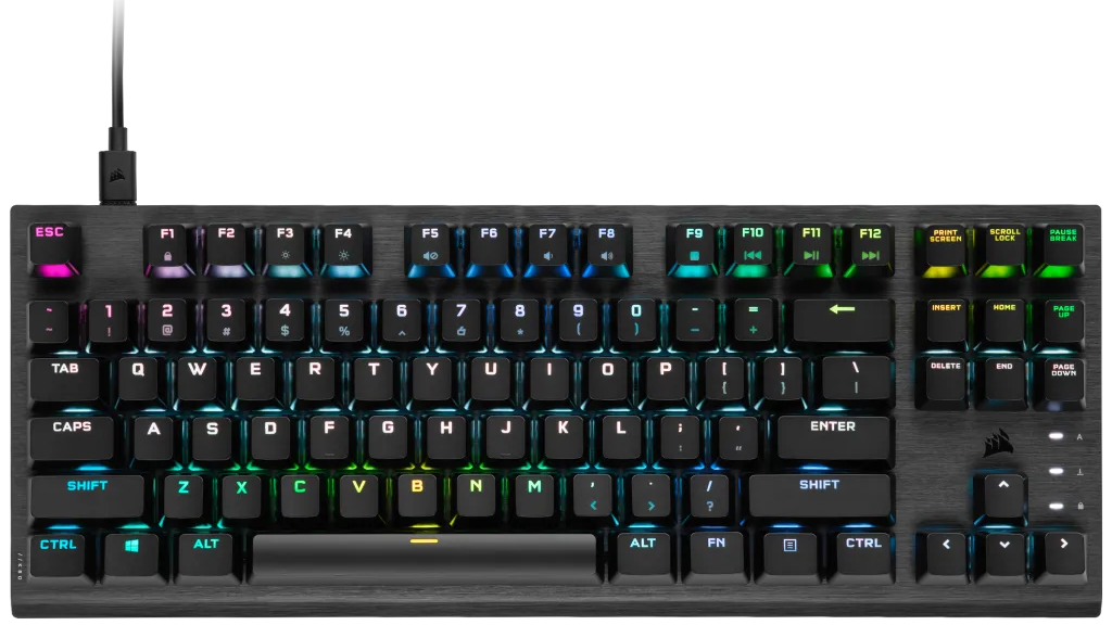 Fekete gamer billentyűzet színes háttérvilágítású billentyűkkel és USB kábellel, fekete háttér előtt.