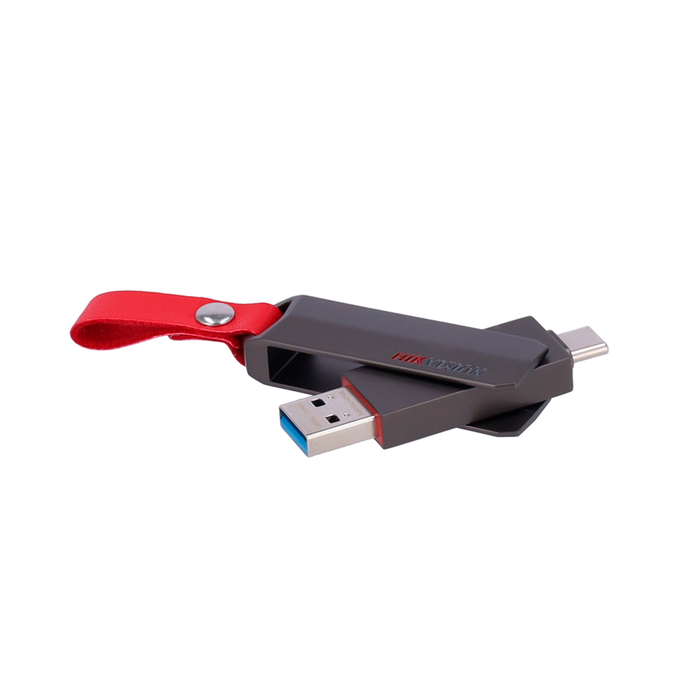Kırmızı kayışlı, koyu gri bir USB sürücüsü, siyah bir arka plan üzerinde.