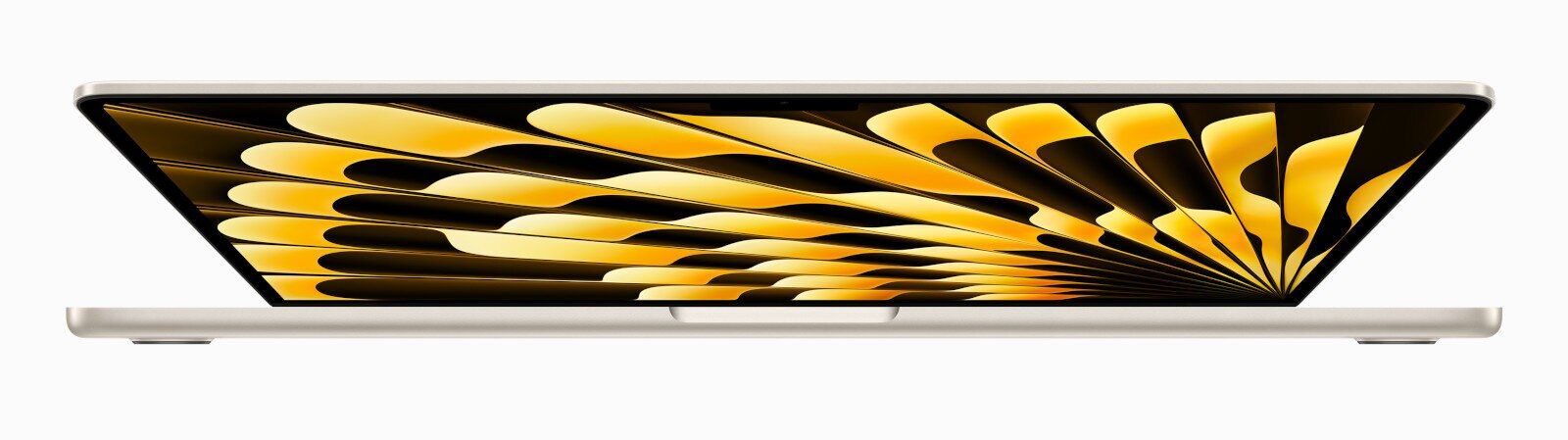 Laptop z boku. Pokrywa otwarta, pokazująca kolorowy wzór. Kolor beżowy.