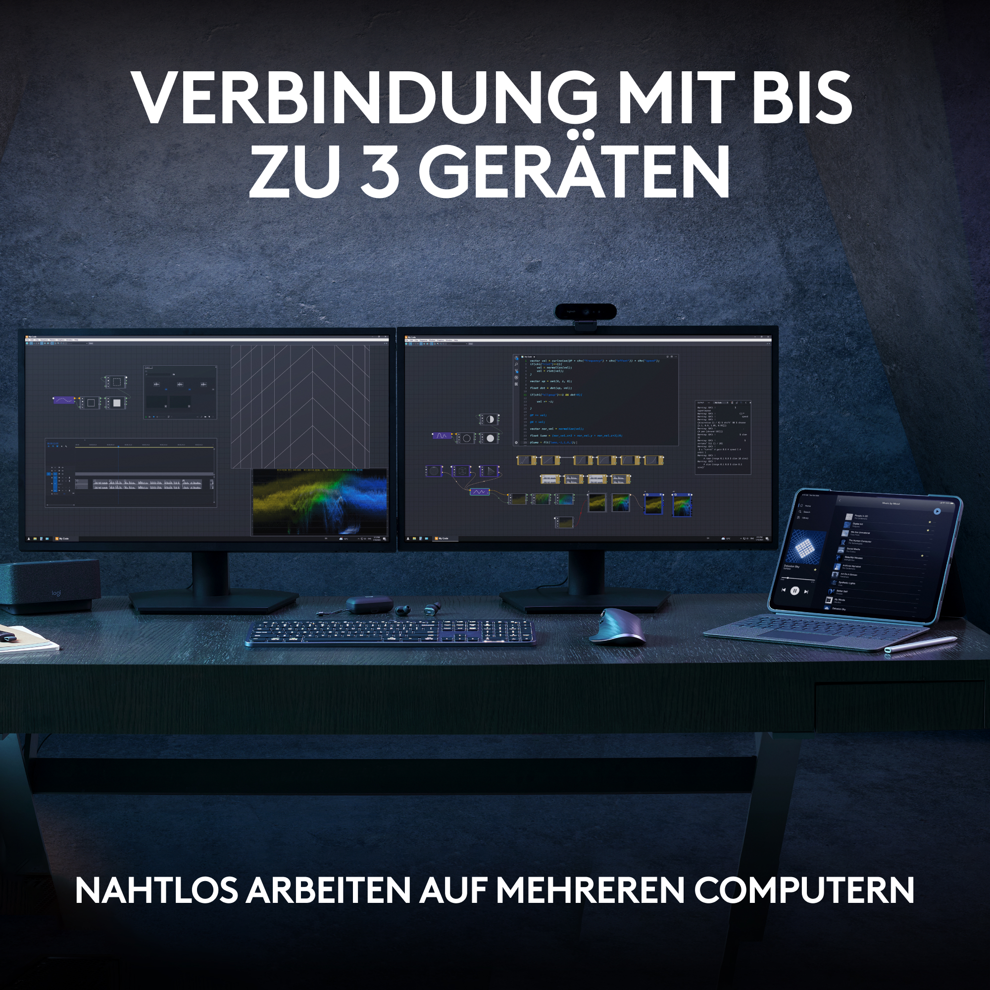 Zwei Computerbildschirme stehen auf einem Schreibtisch mit Tastatur, Maus und Tablet. Text oben.