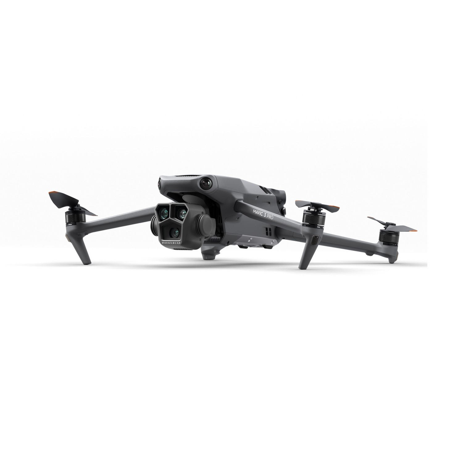 Gray drone with multiple propellers, camera and landing gear, against white background.