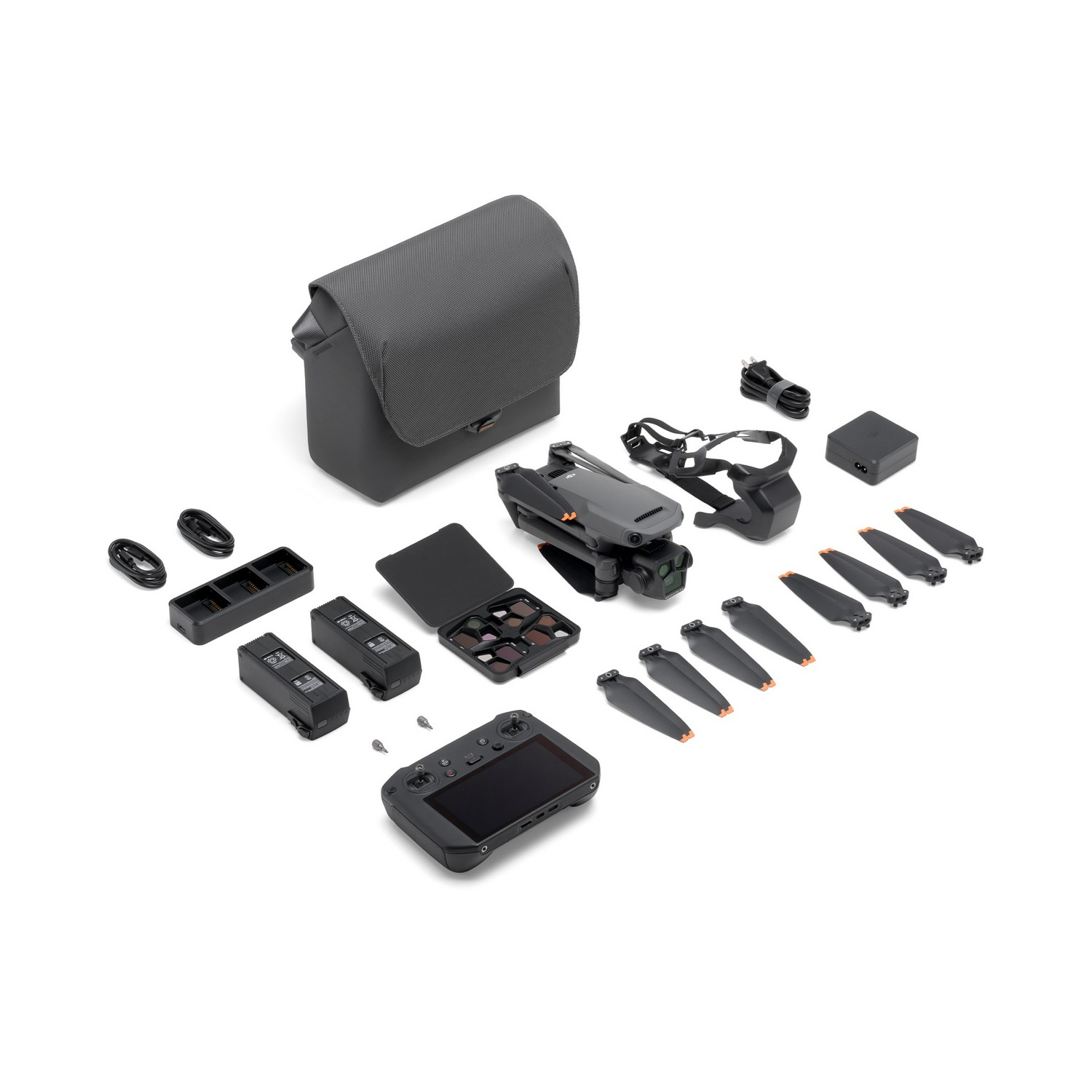 A drone kit with many accessories: a bag, a controller, batteries, propellers. White background.