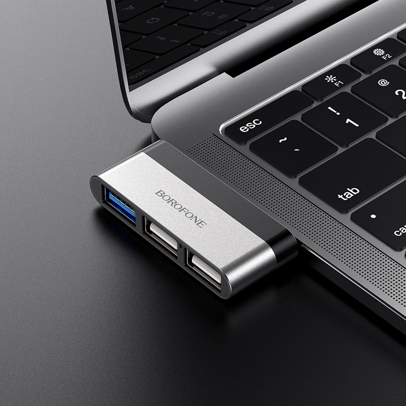 Ezüst USB hub laptophoz csatlakoztatva, USB portokkal.