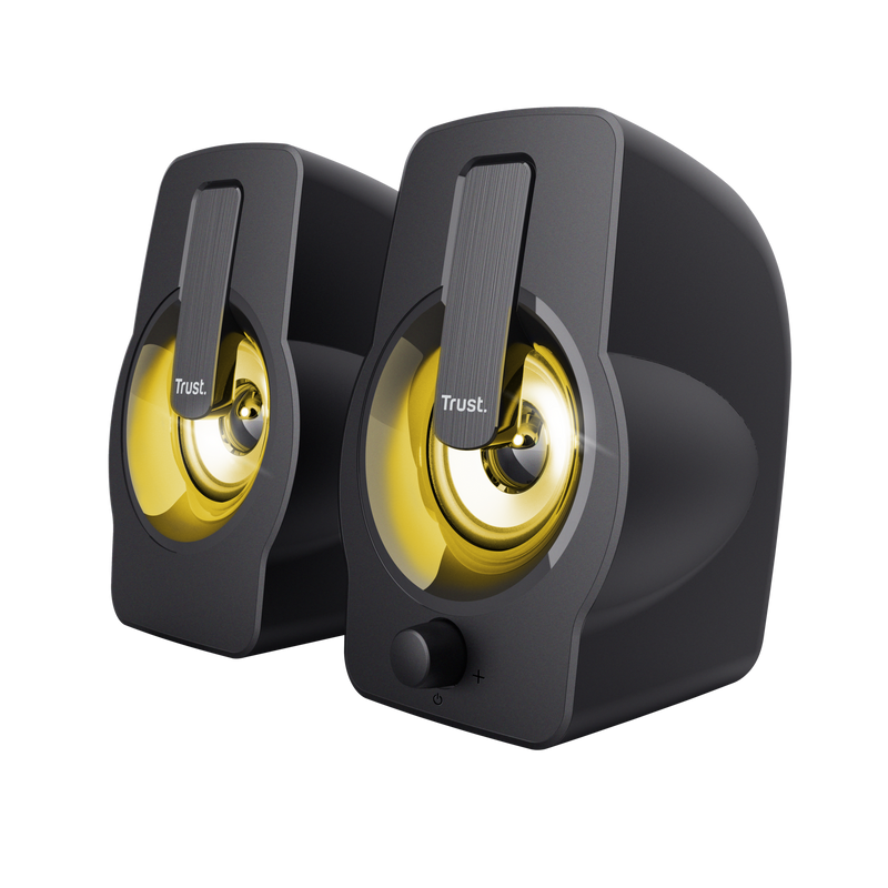 Dos altavoces Trust negros con centros iluminados en amarillo y control de volumen.