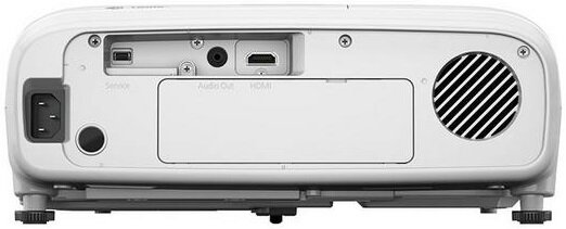 Tył białego projektora z portami serwisowymi, audio i HDMI, z głośnikiem.