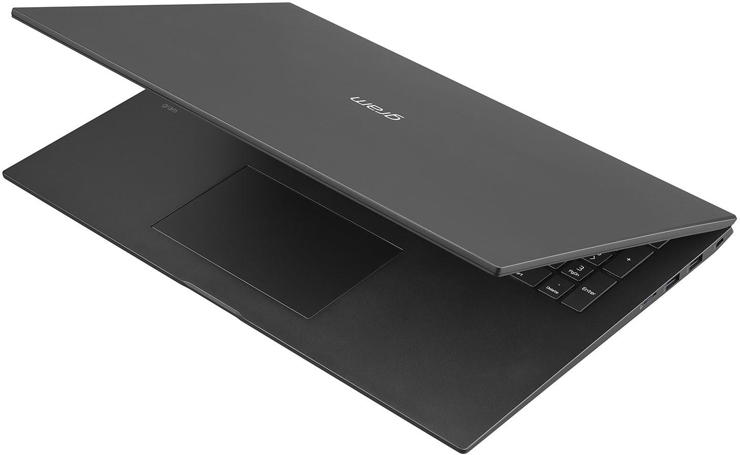 Ein geöffneter schwarzer Laptop mit Touchpad, Tastatur und sichtbarem Bildschirm.