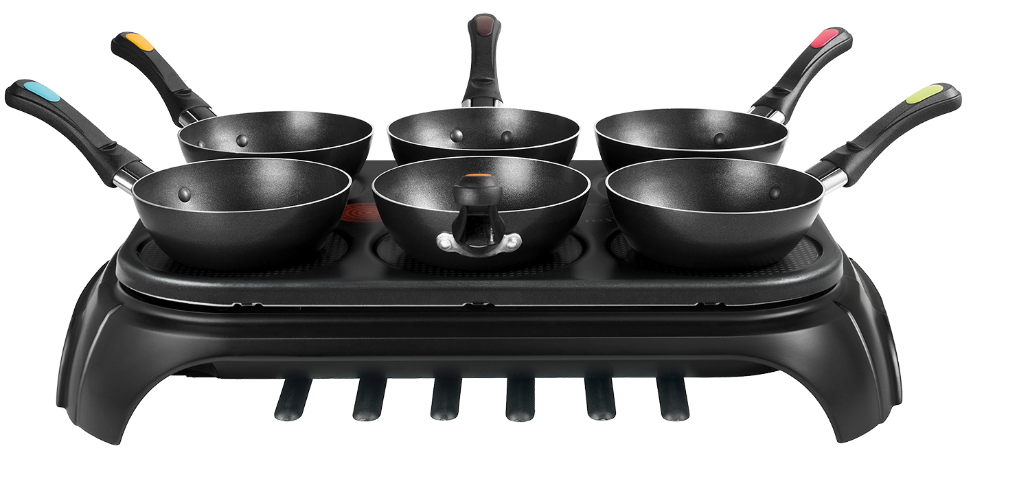 Set of six black pans with colored handles on a black cooking surface.