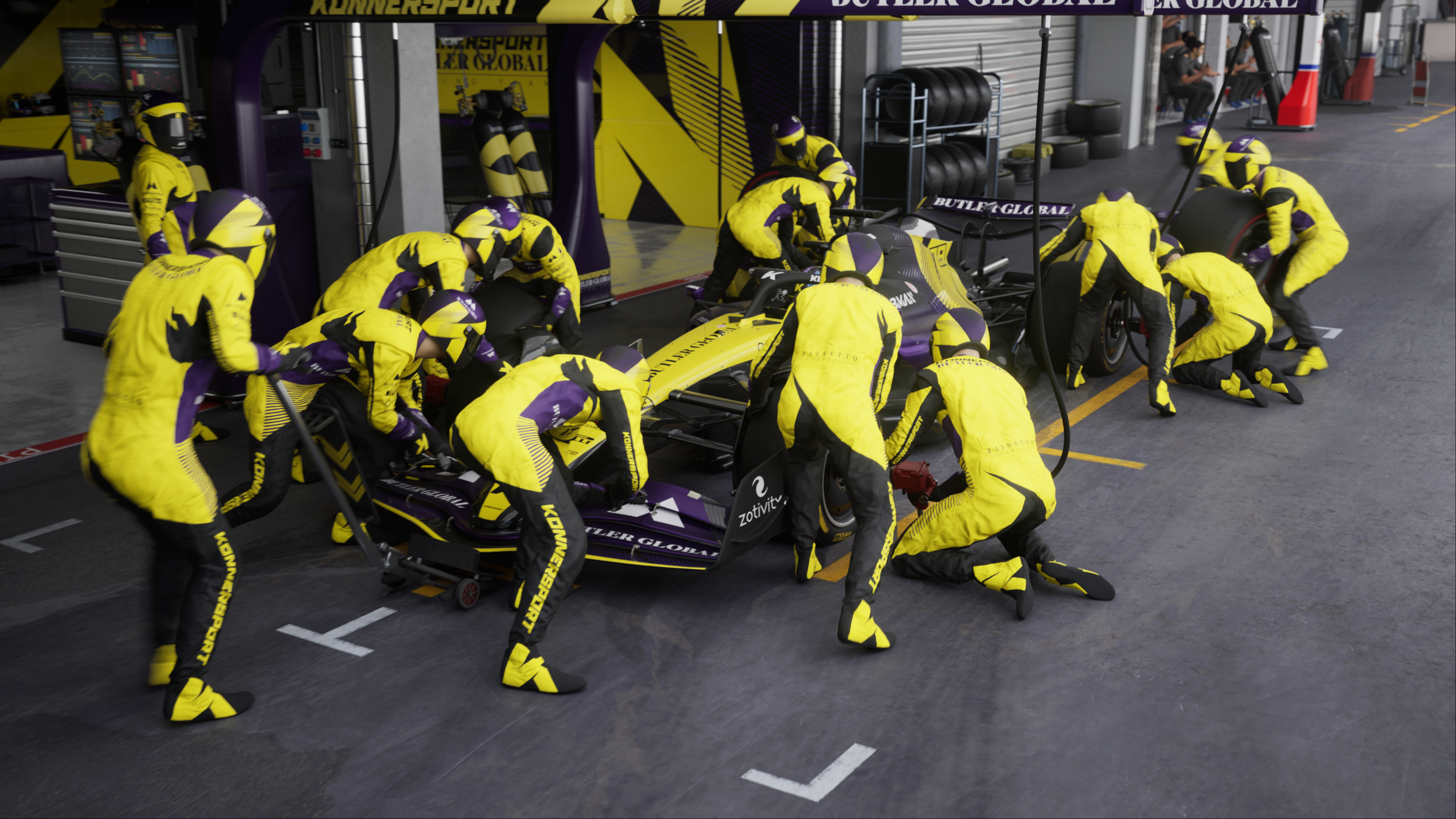 Boxenstopp eines Rennwagenteams, Mechaniker in gelben Anzügen arbeiten am Auto in der Garage.