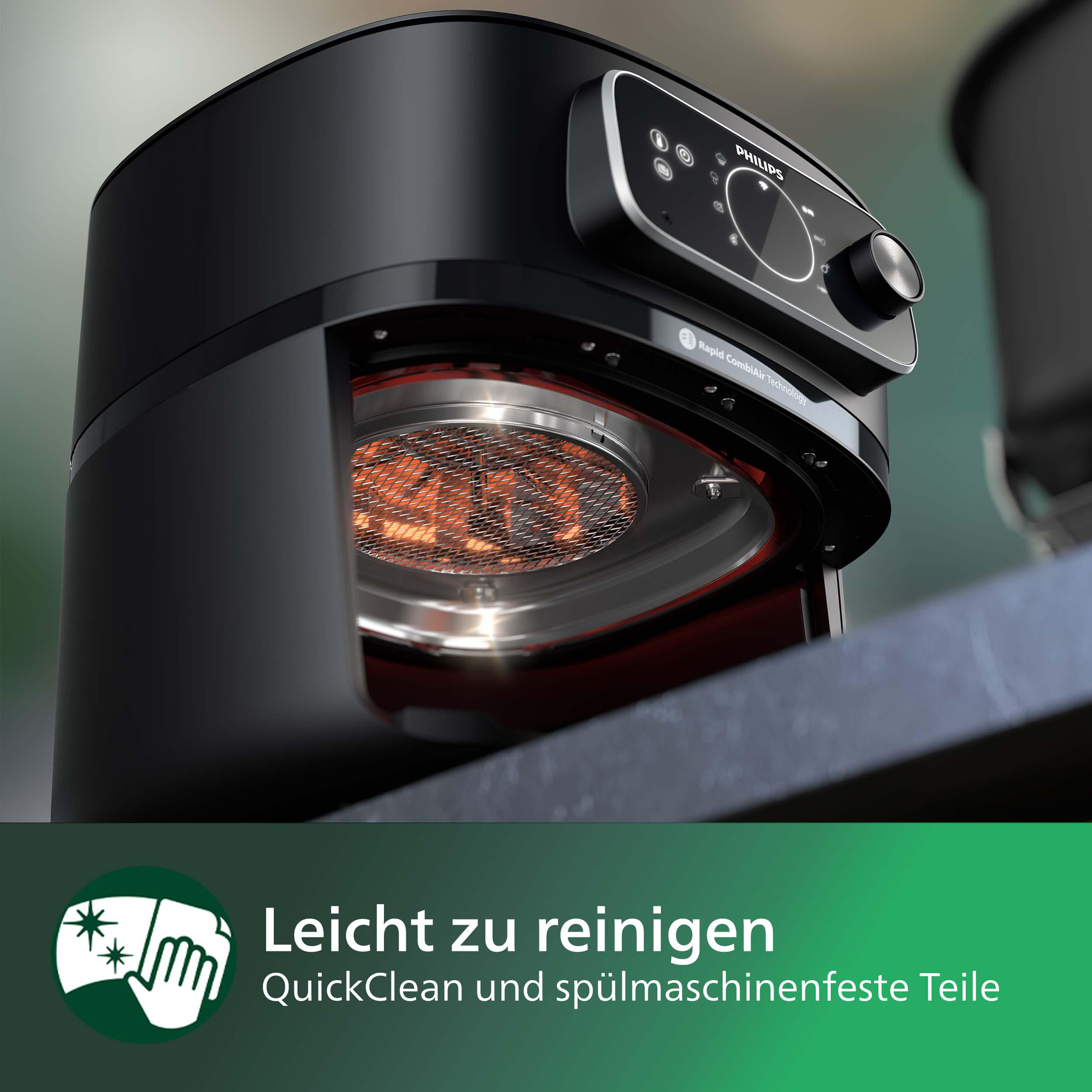 Schwarze Philips Heißluftfritteuse auf einer Theke, teilweise geöffnet, mit Text zur Reinigung.