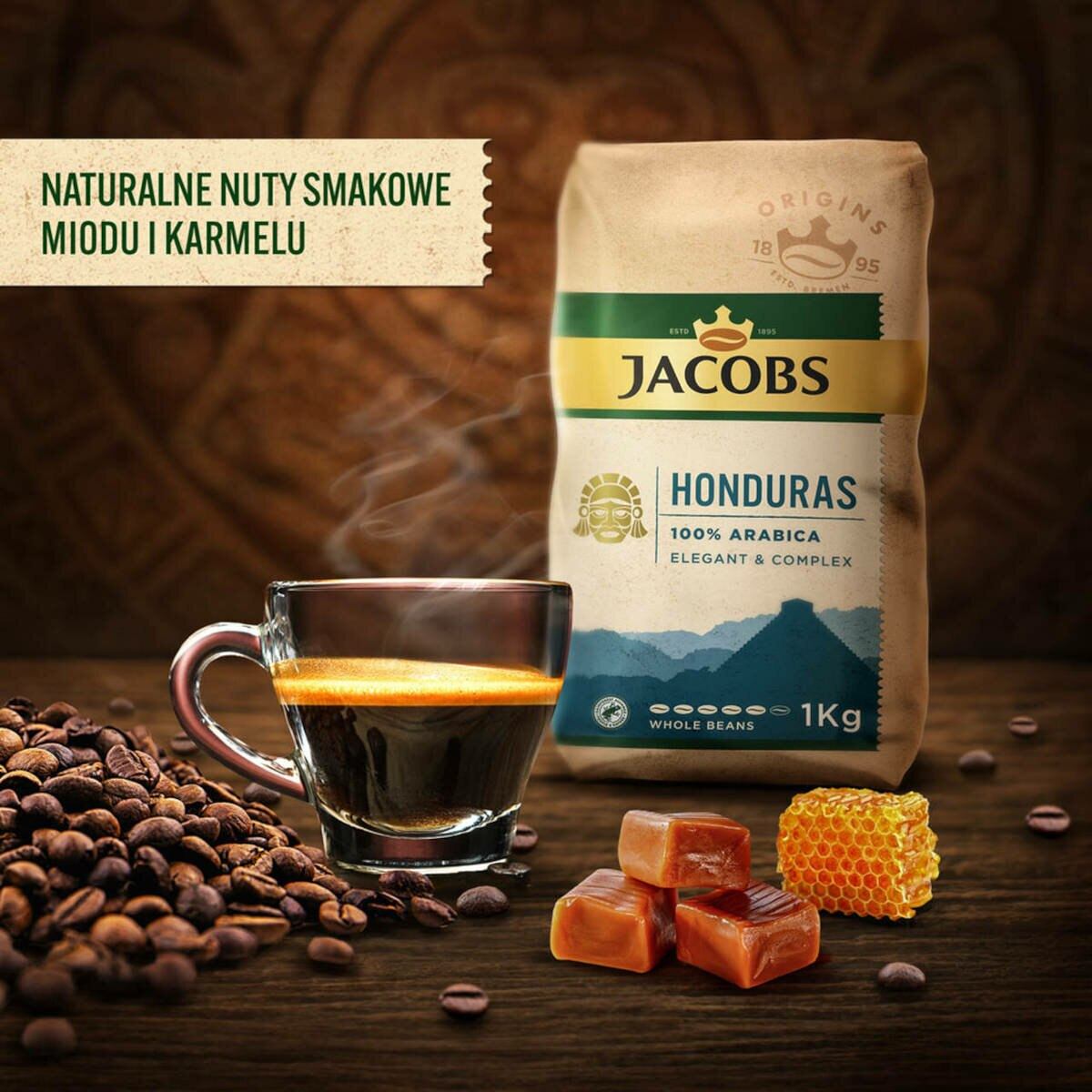 Torba kawy Jacobs, filiżanka kawy, ziarna, karmel, miód, drewniana powierzchnia, brązowe tło.