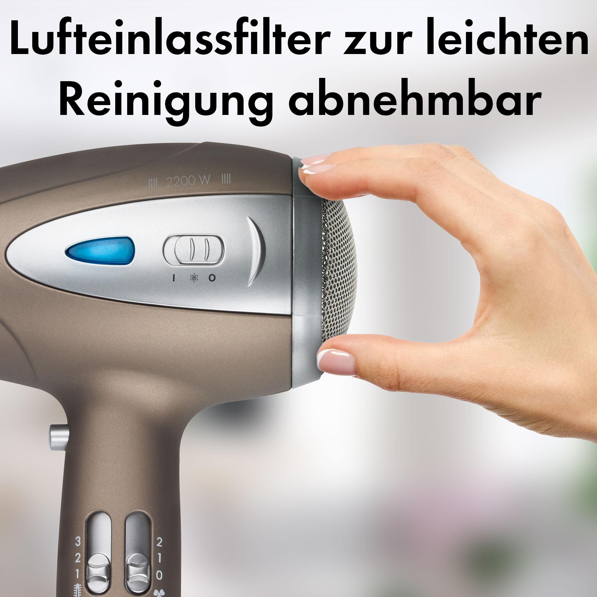 Eine Hand hält einen Fön, mit Text über den abnehmbaren Luftfilter und die Trocknersteuerung.