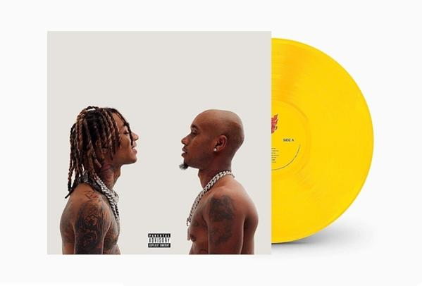 Albumcover mit zwei Männern, die sich ansehen. Einer hat Dreadlocks, der andere ist kahl. Gelbes Vinyl.
