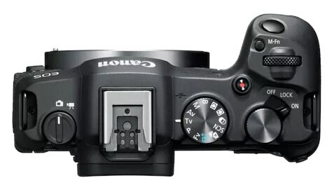 Widok z góry na czarny aparat Canon, pokazujący pokrętła, przyciski i mocowanie obiektywu.