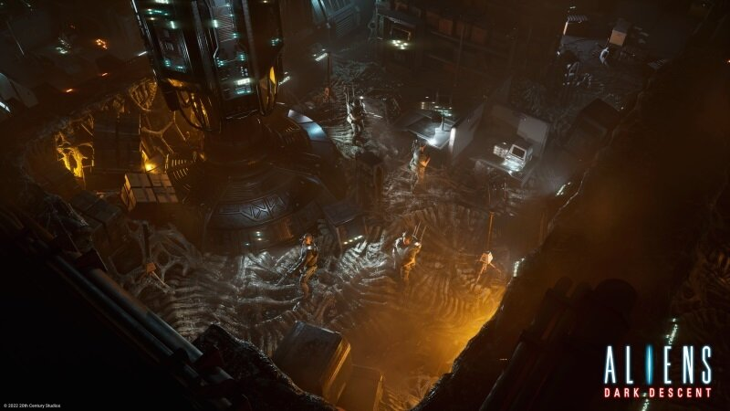 Widok z góry na środowisko science fiction z gry wideo, pokazujący ciemny, jaskiniowy obszar ze strukturami.