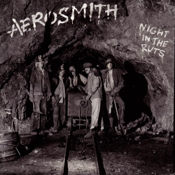 Schwarz-Weiß-Foto von Bergleuten in einem Minentunnel, mit Text 'Night in the Ruts'.