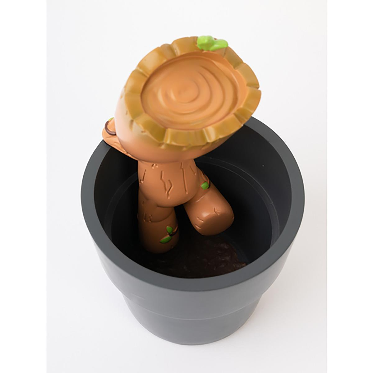 Eine Groot-Figur in einem Blumentopf. Die Figur ist braun und der Topf grau.