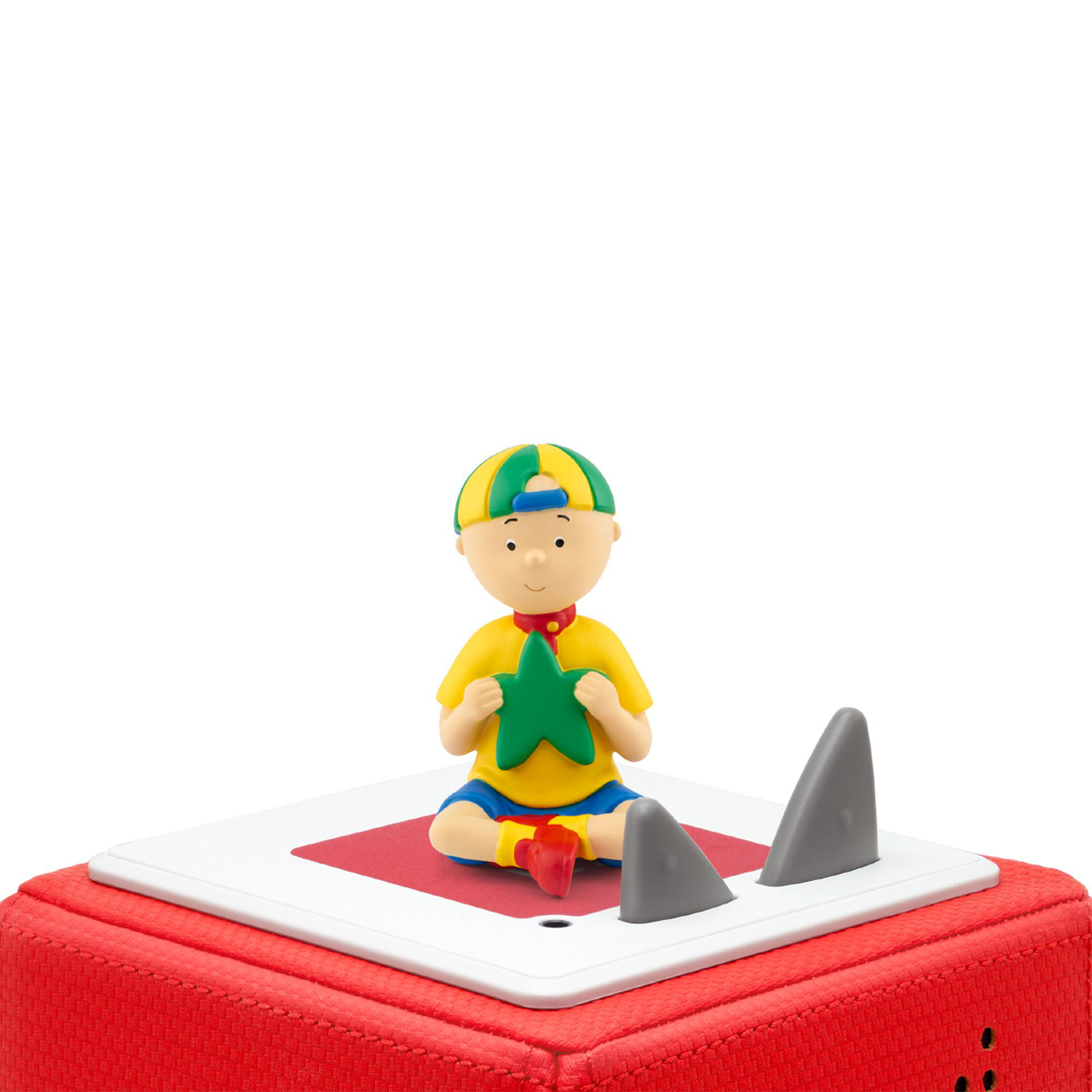 Caillou-Figur sitzt auf einem roten Block. Ein Stern in seinen Händen. Graue Haifischflossen hinter ihm.