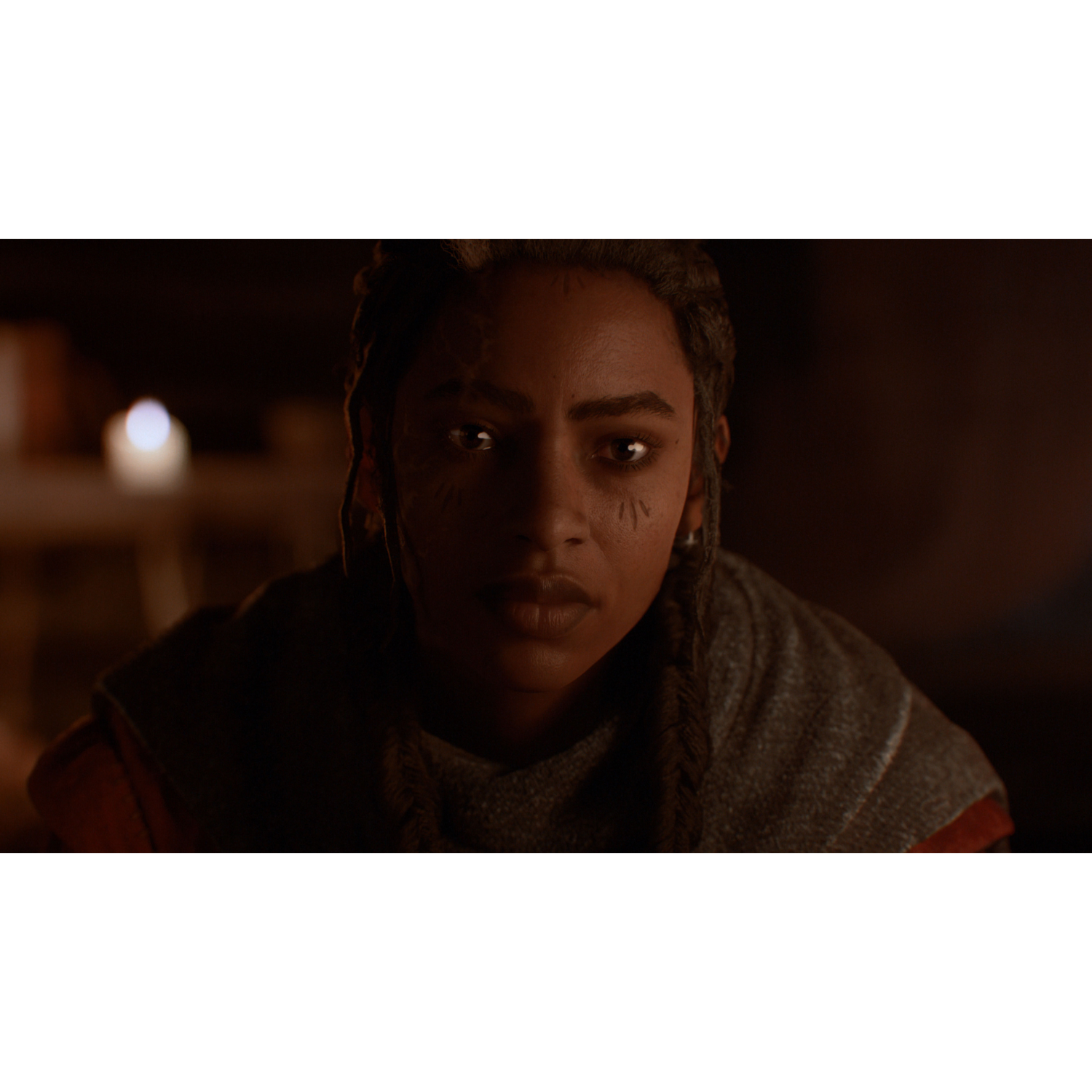 A woman with dark skin, braided hair, and face markings, looking straight at the camera.