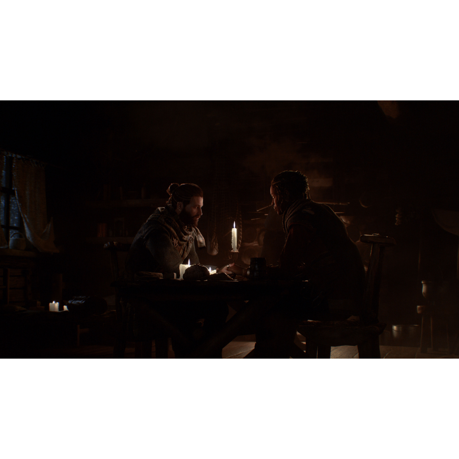 Two people sit at a table in a dimly lit room, lit by a candle on table.