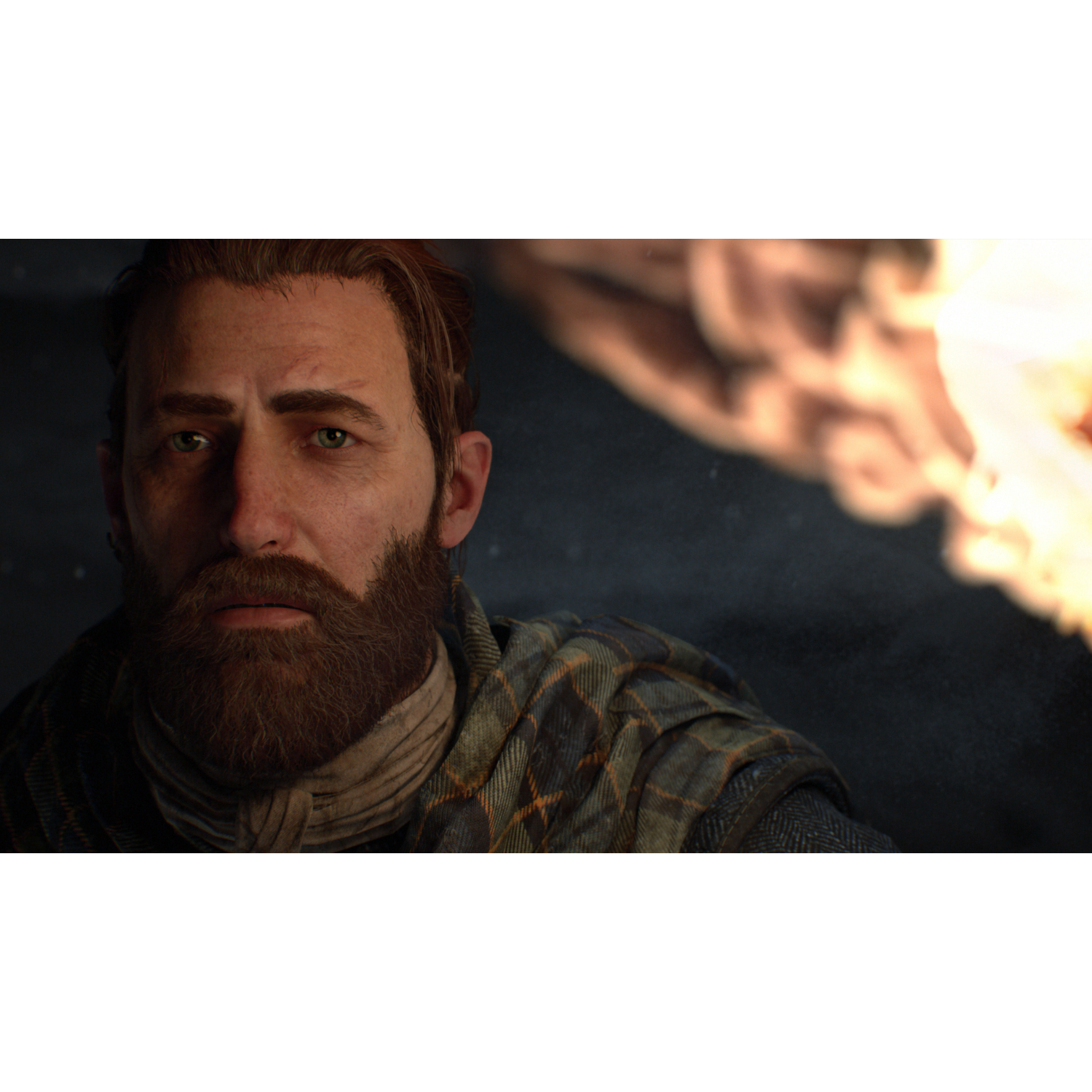 A man with a beard, looking at a fire. He is wearing a plaid scarf.