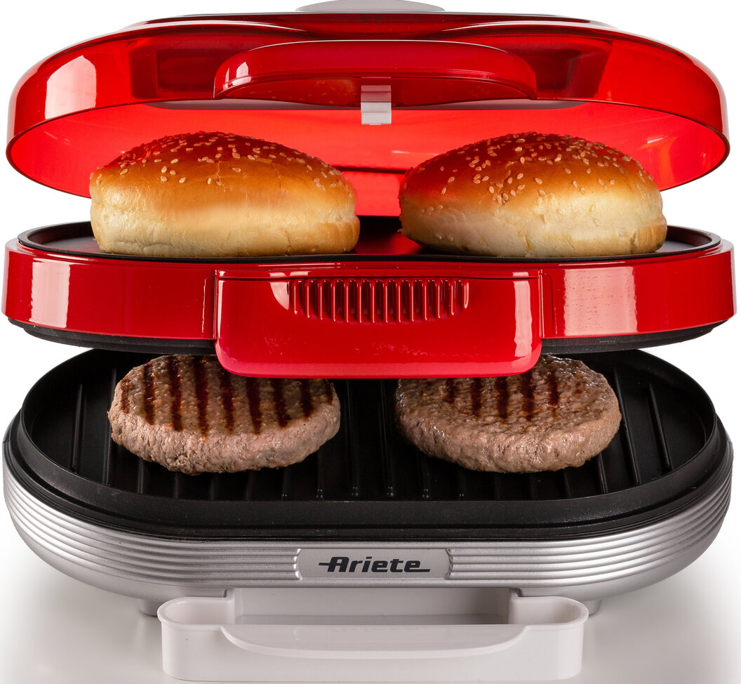Macchina per hamburger con hamburger e panini su una macchina rossa e argento.