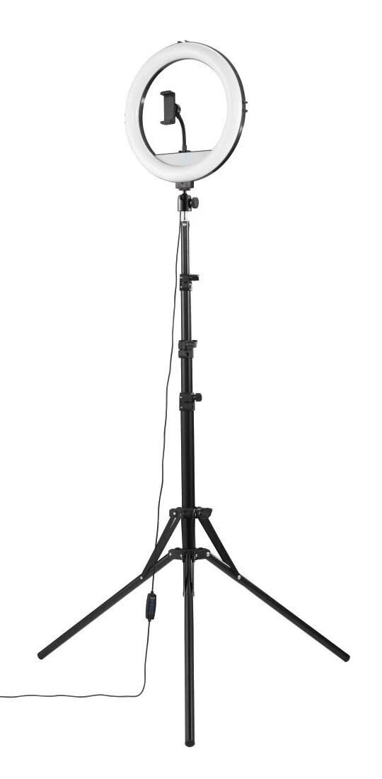 Czarna lampa pierścieniowa na statywie. Dołączony jest uchwyt na telefon. Białe tło.