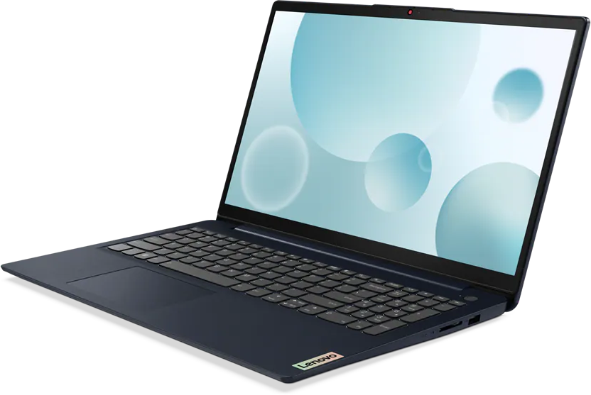 Kék laptop kék köröket mutató képernyővel. A laptop sötét felületen van.
