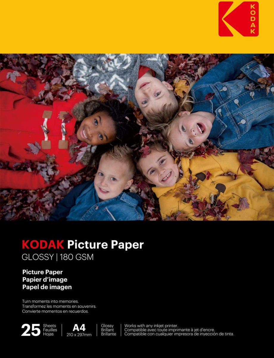 Kodak fotópapír doboz gyerekarcokkal, őszi levelekkel körülvéve.