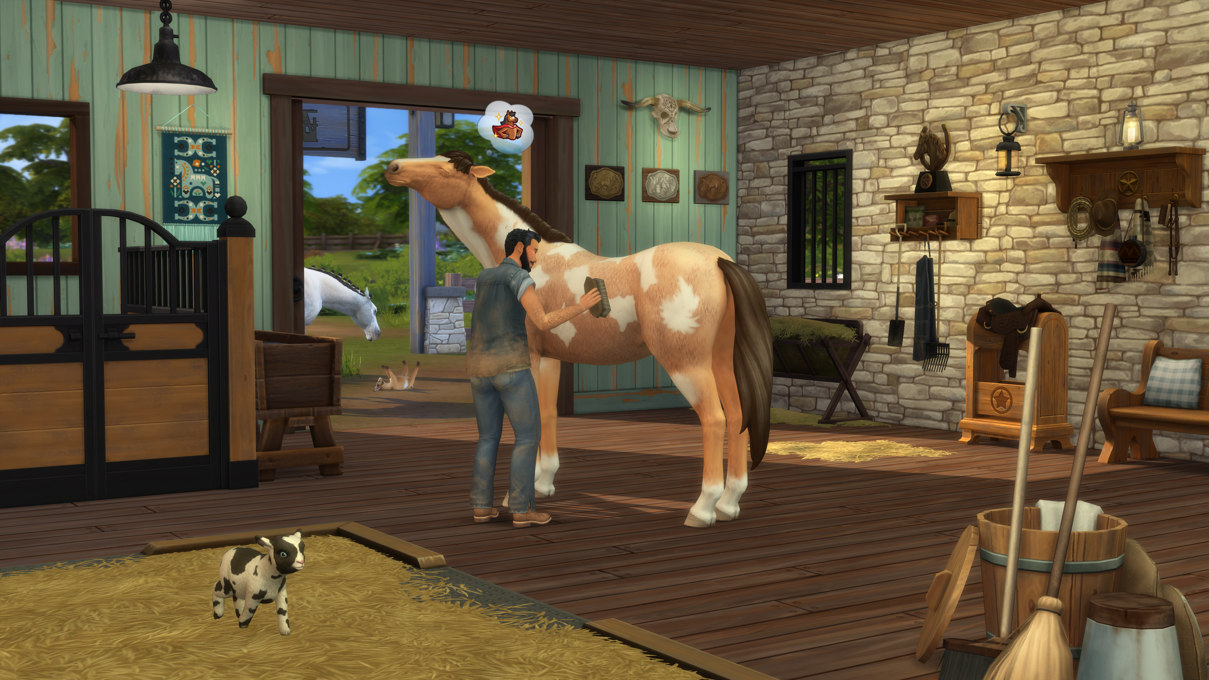 Mann pflegt Pferd im Stall, Kalb und Pferd im Hintergrund.