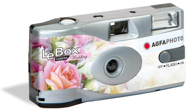 Disposable camera with floral design, white background, and flash.