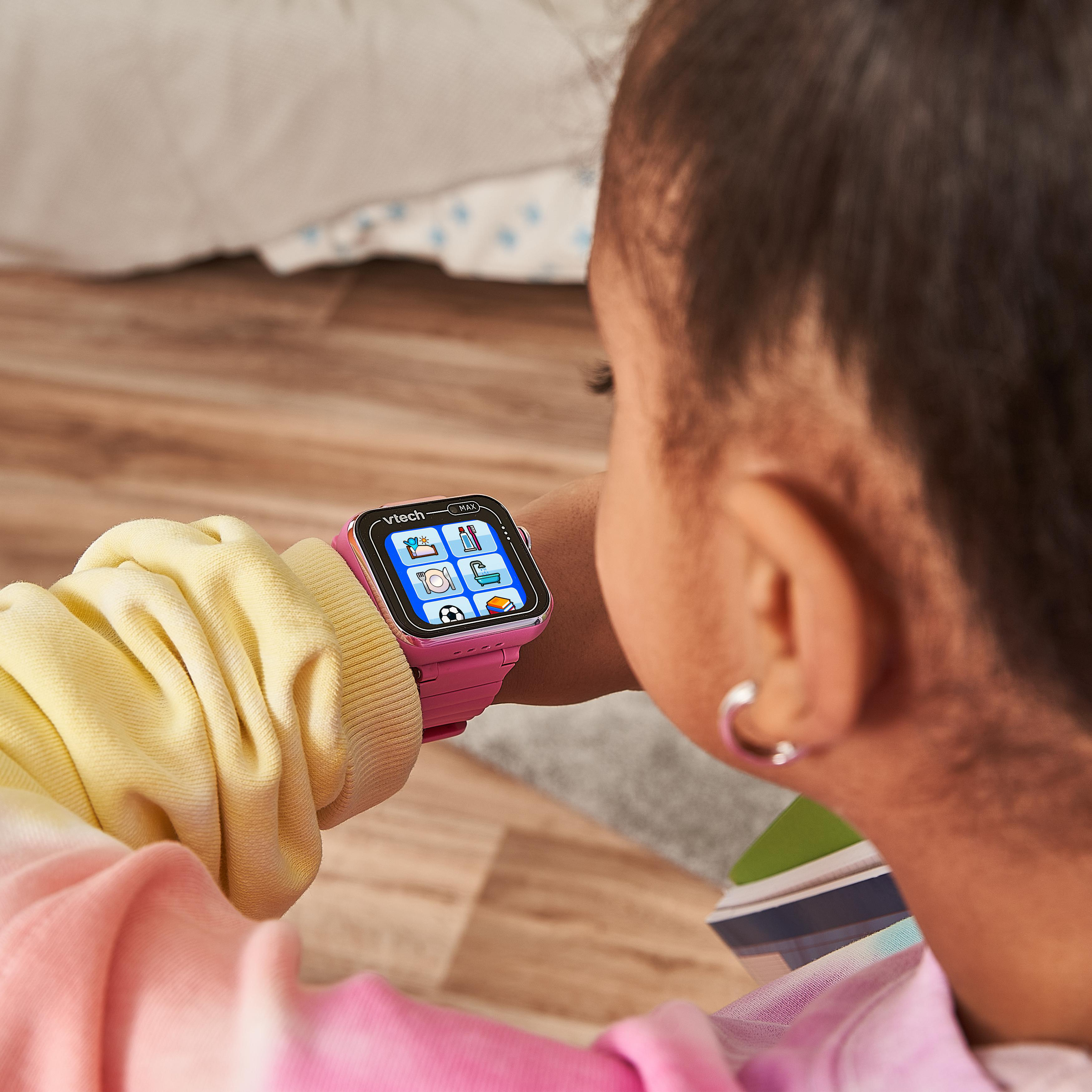 Ein Kind trägt eine rosa Smartwatch und schaut auf den Bildschirm.