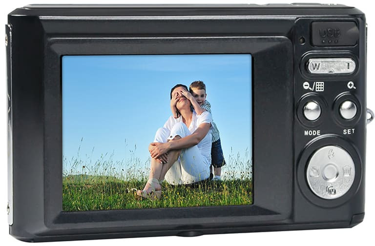 A digital camera with a screen displaying a photo of a woman and boy.