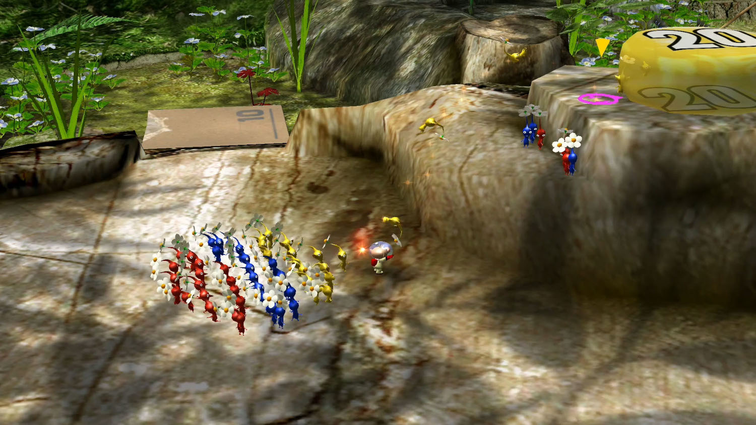 Une scène de jeu avec des créatures Pikmin. Le chiffre jaune 20 est affiché sur une plateforme.