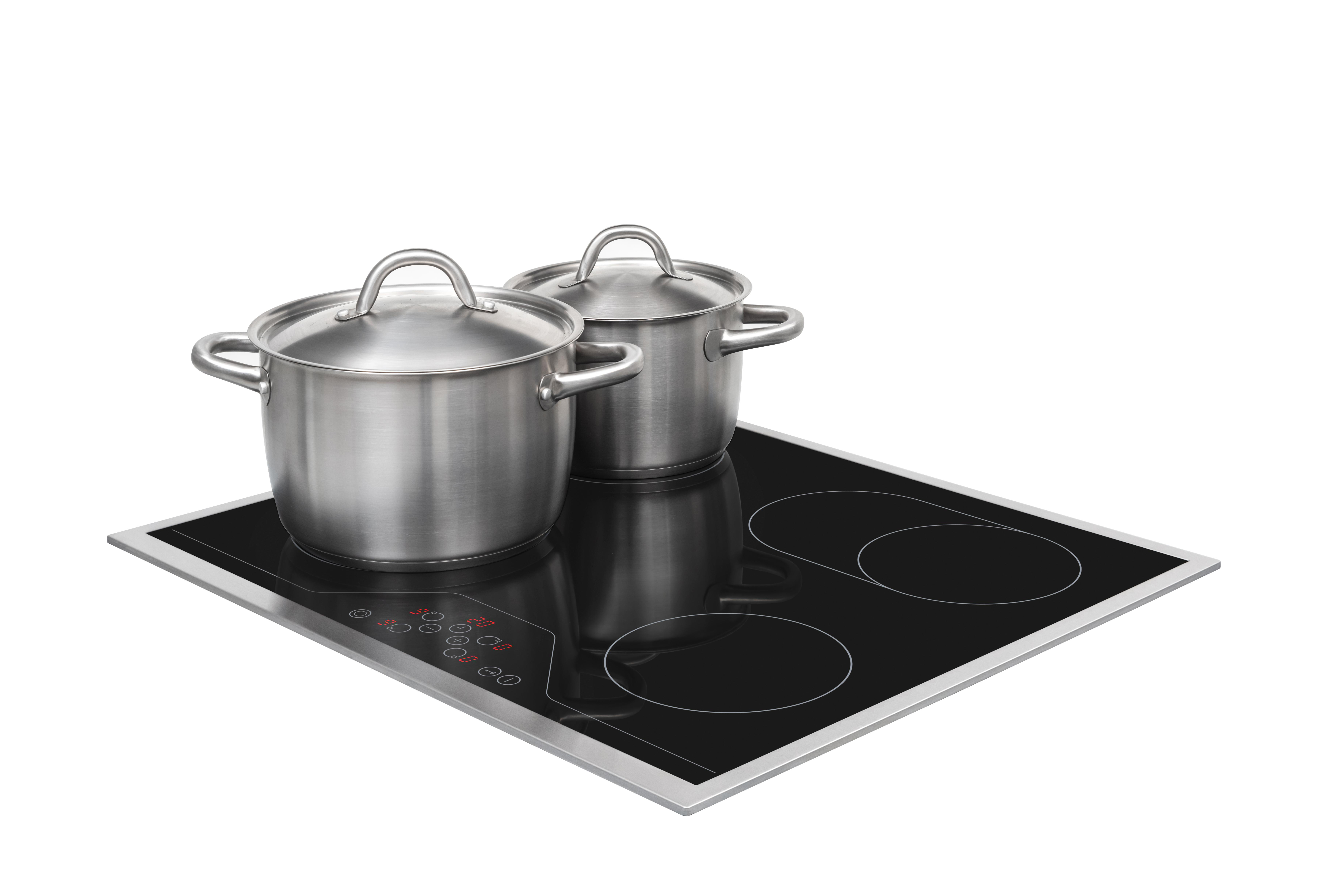 Zwei Edelstahltöpfe auf einem schwarzen Elektrokochfeld, bereit zum Kochen.