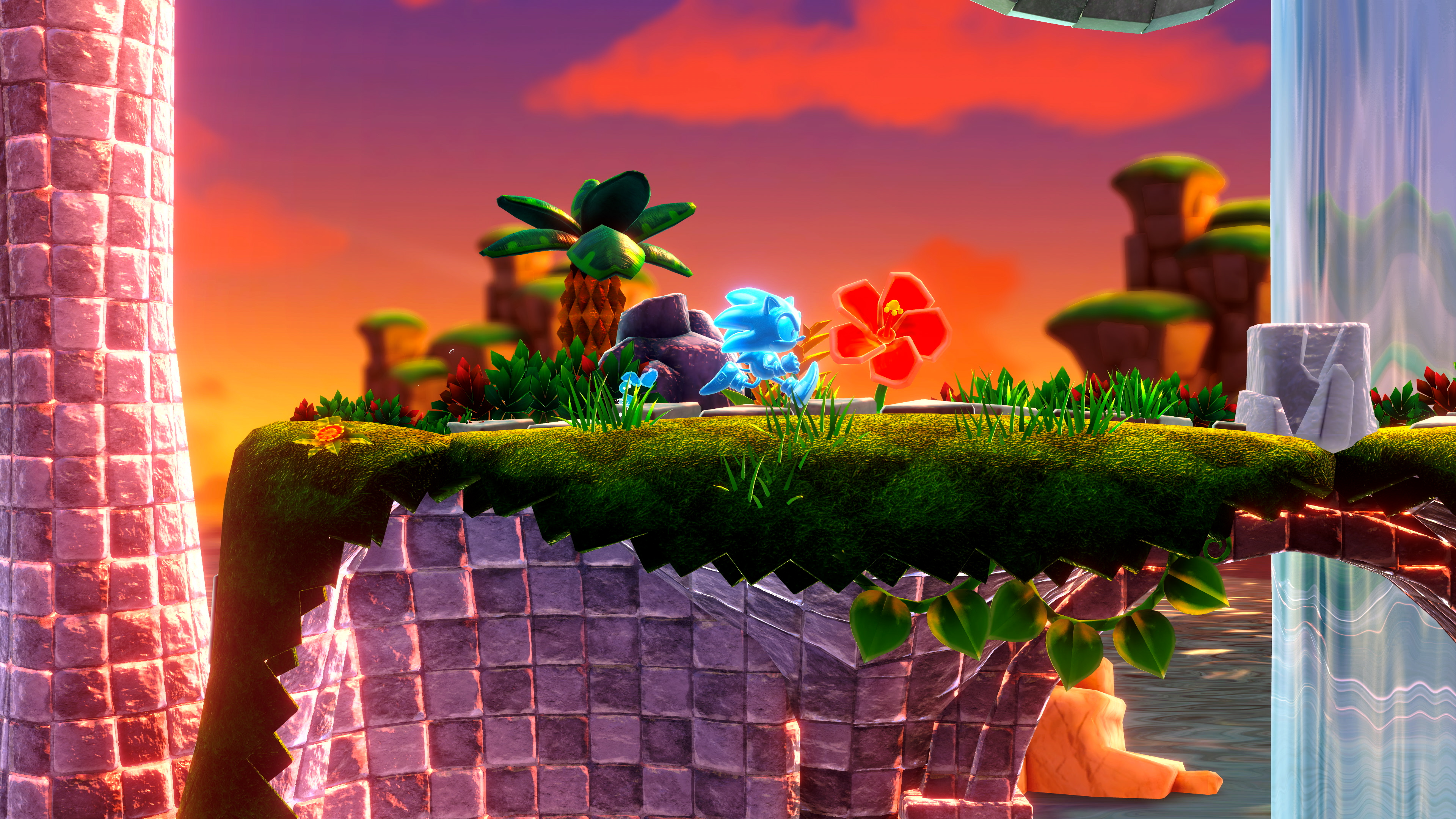 Sonic et un ami sur une plateforme verte avec des fleurs, ciel orange en arrière-plan.