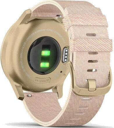 Zbliżenie tyłu smartwatcha. Jest złoty z różowym paskiem z tkaniny. Zegarek pokazuje dwa zielone światła. Widoczne szczegóły.