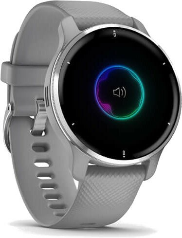 Szary smartwatch z czarnym ekranem wyświetlającym kolorową falę dźwiękową i ikonę głośności.