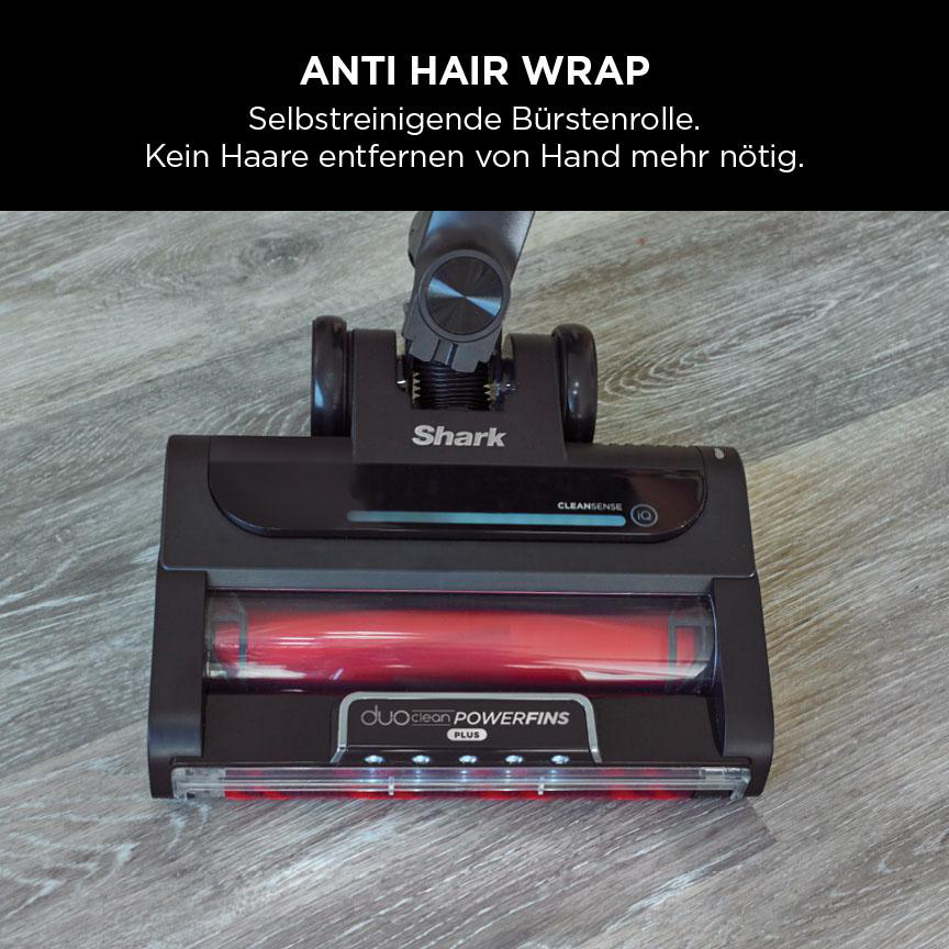Staubsaugerkopf mit roter Bürste und Text: 'Anti Hair Wrap', grauer Holzboden.