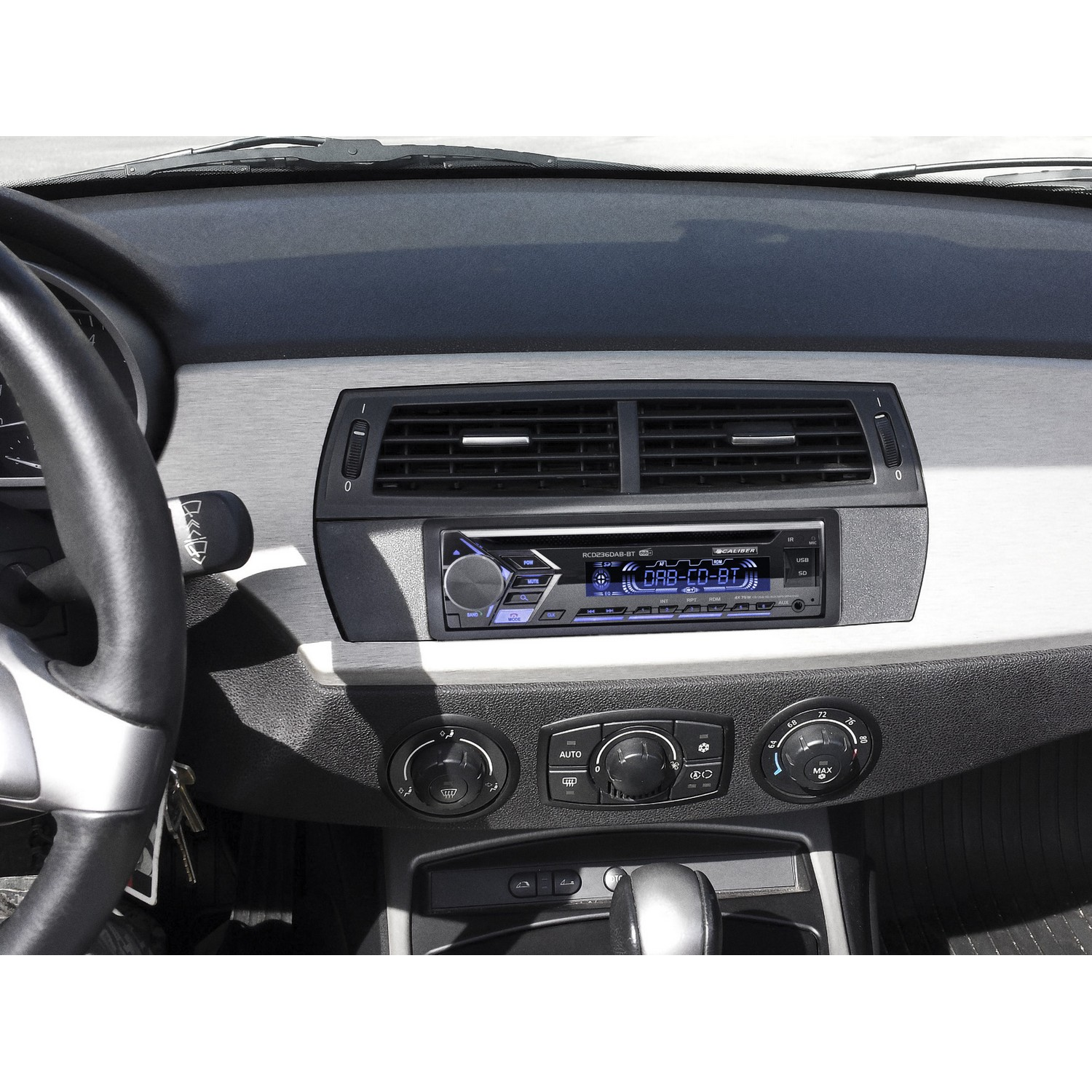 Auto-interieur, radio met display, ventilatieopeningen en klimaatregelaars.