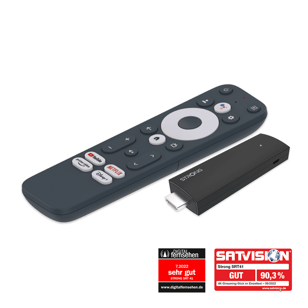 Eine Fernbedienung und ein schwarzer Streaming-Stick. Die Fernbedienung ist grau mit mehreren Knöpfen. Der Stick hat einen USB-Anschluss.
