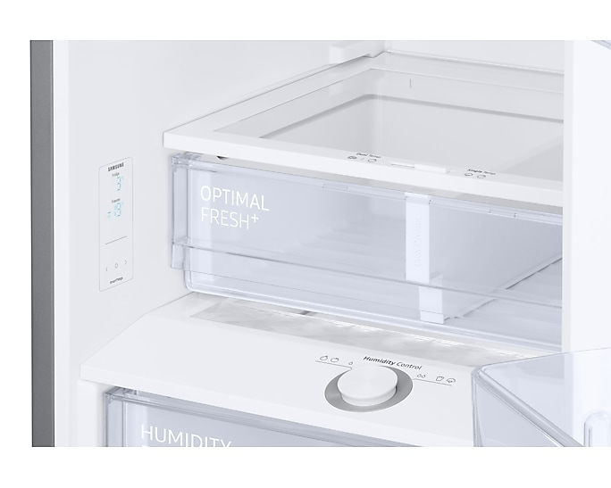 Hűtőszekrény belseje 'Optimal Fresh+' és 'Humidity' feliratú fiókokkal.