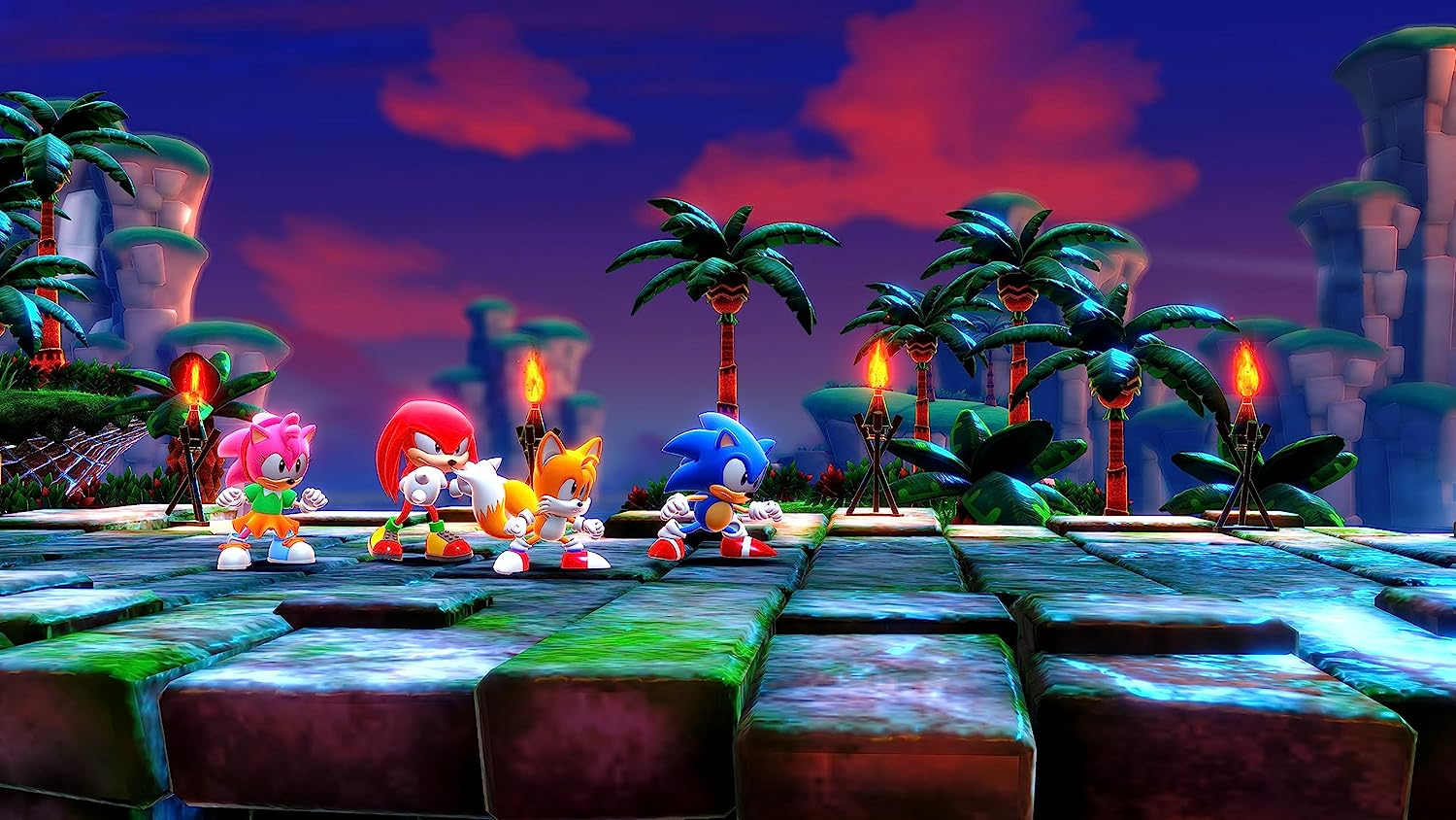 Grupo de personajes de Sonic en una plataforma, con palmeras y un fondo de puesta de sol, colores vibrantes.